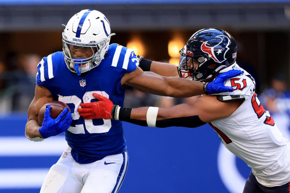 INDIANAPOLIS, INDIANA - OCTOBER 17: Jonathan Taylor #28 of the Indianapolis Colts runs the ball while being chased by Kamu Grugier-Hill #51 of the Houston Texans at Lucas Oil Stadium on October 17, 2021 in Indianapolis, Indiana. (Photo by Justin Casterline/Getty Images)