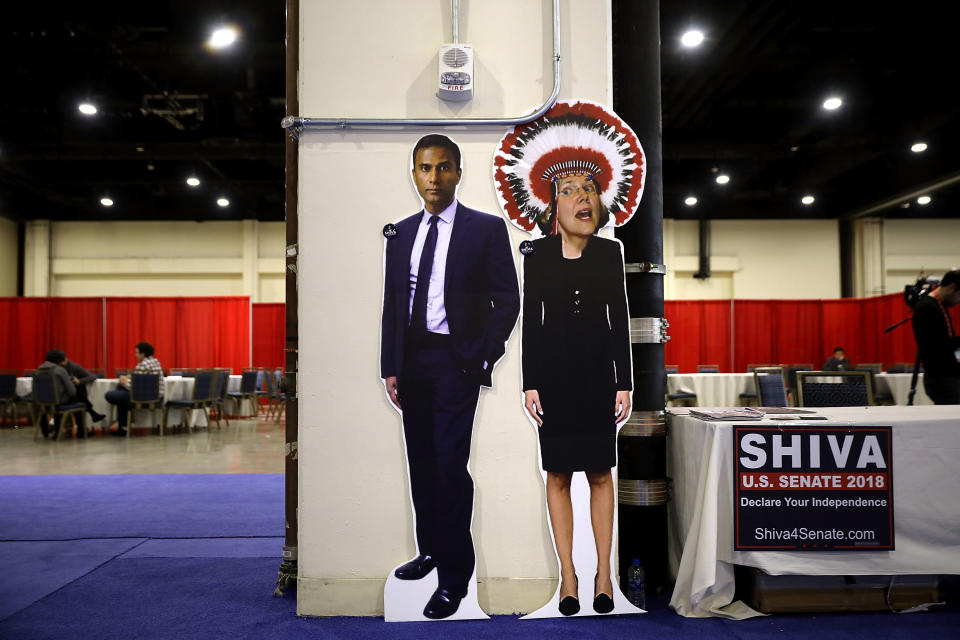 Shiva Ayyadurai, an independent who ran against Warren in 2018, set up this racist, photoshopped image of her wearing a Native American headdress at the Conservative Political Action Conference in National Harbor, Md. in February 2018. (Photo: Chip Somodevilla via Getty Images)