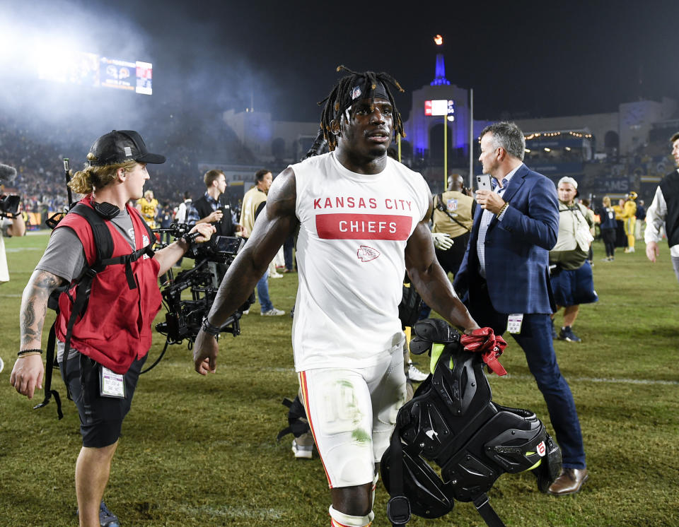 FILE - In this Nov. 19, 2018, file photo, Kansas City Chiefs wide receiver Tyreek Hill walks off the field after an NFL football game against the Los Angeles Rams, in Los Angeles. The Kansas City Chiefs have made a habit of inciting controversy during the NFL draft in the Andy Reid era by acquiring players that have a history of off-the-field issues. The team took a chance on cornerback Marcus Peters, who was traded away after getting into trouble with coaches. It drafted running back Kareem Hunt, then quickly cut him when he kicked a woman in a hotel hallway. And it picked wide receiver Tyreek Hill, who is currently dealing with a domestic violence case that centers on the 3-year-old child he shares with his fiance.(AP Photo/Kelvin Kuo, File)