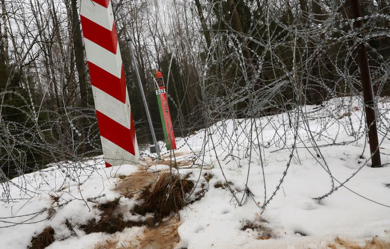 FILE PHOTO: Workers work at construction site of barrier at border between Poland and Belarus