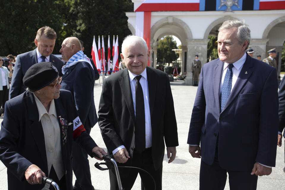Poland's main ruling party leader Jaroslaw Kaczynski, center, attends a wreath laying ceremony marking national observances of the anniversary of World War II in Warsaw, Poland, Sept. 1, 2022. World War II began on Sept. 1, 1939, with Nazi Germany's bombing and invading Poland, for more than five years of brutal occupation. (AP Photo/Michal Dyjuk)