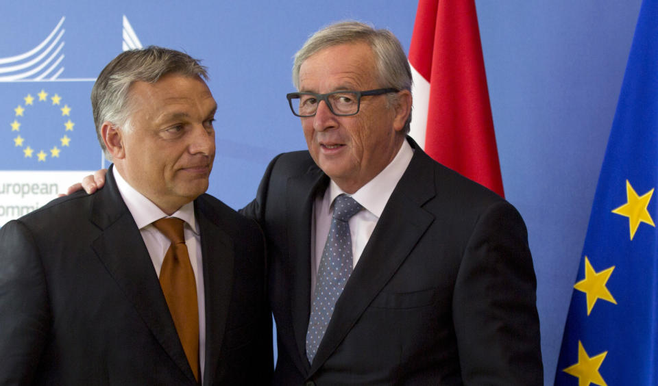 In this Thursday, Sept. 3, 2015, file photo, European Commission President Jean-Claude Juncker, right, puts his hand on the shoulder of Hungarian Prime Minister Viktor Orban, left, prior to a meeting at EU headquarters in Brussels. Hungarian Prime Minister Viktor Orban is visiting EU officials on Thursday to discuss the current migration crisis. (AP Photo/Virginia Mayo, File)