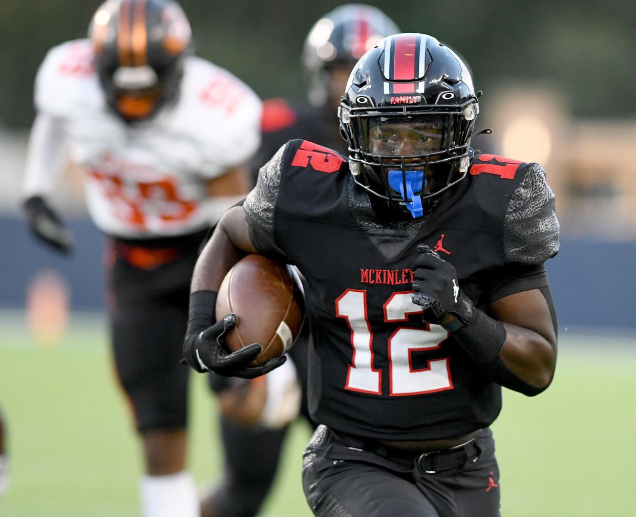 McKinley's Nino Hill runs for a first down in the first half against Green, Friday, Sept. 15, 2023, in Canton.