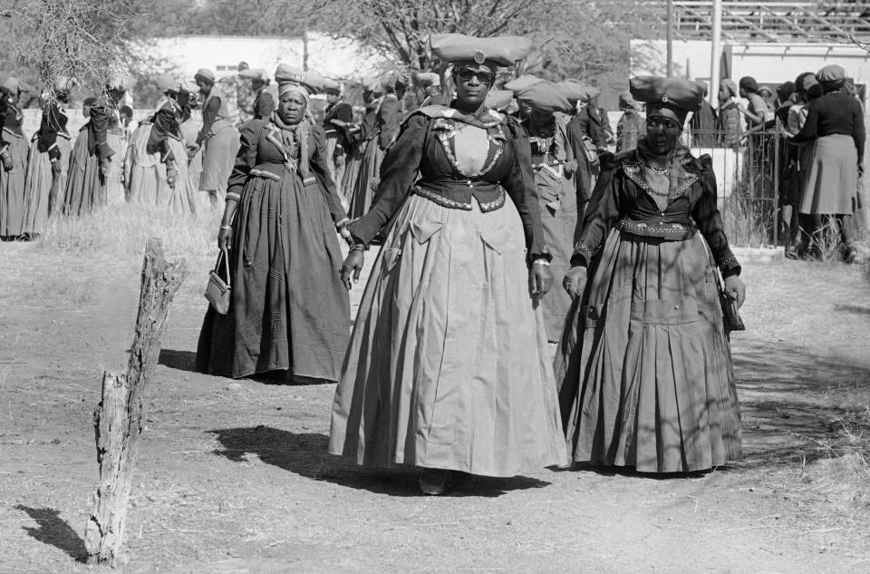 FILE - In this July 4, 1981 file picture women of the Herero tribe show their traditional dress in Windhoek. Germany says Friday Jan. 6, 2017 it could make further payments to Namibia for the killing of 65,000 tribes people by German colonial troops during the early 20th century. Foreign Ministry spokesman Martin Schaefer says the two-year talks with Namibia’s government “aren’t easy because it’s a difficult topic.” His comments come a day after representatives of the Herero and Nama tribes filed a class action complaint against the German government in the United States, seeking reparations and a place at the negotiating table. (AP Photo/JJ,file)