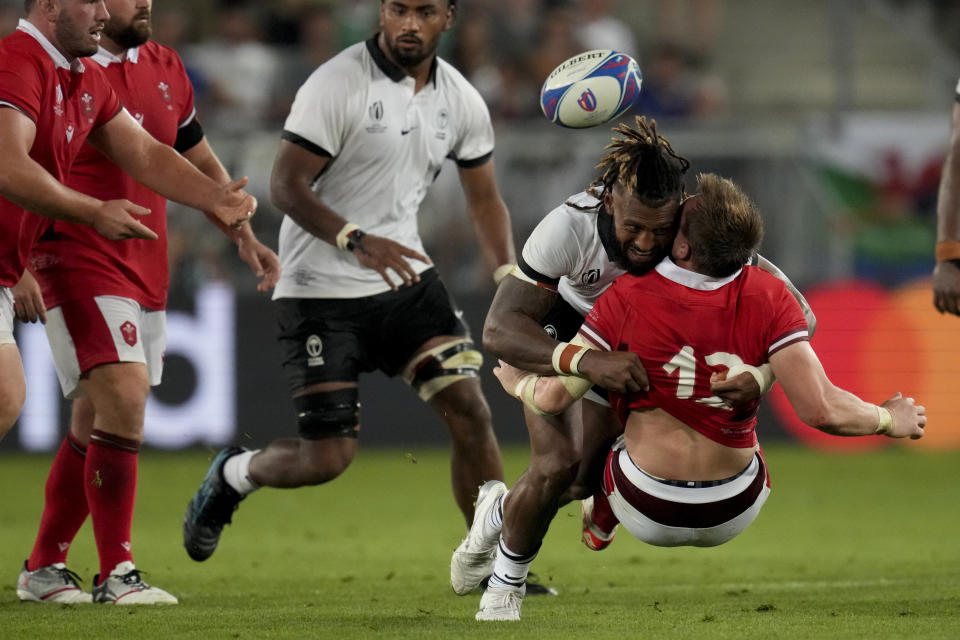 Wales' George North, below, is tackled by Fiji's Waisea Nayacalevu during the Rugby World Cup Pool C match between Wales and Fiji at the Stade de Bordeaux in Bordeaux, France, Sunday, Sept. 10, 2023. (AP Photo/Themba Hadebe)