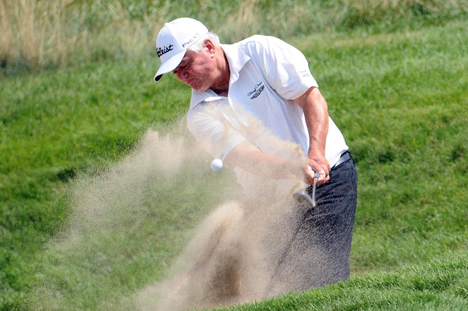 Scott Simpson (USA) hits out of a bunker on the 14th hole during the second round of the U.S. Senior Open at Indianwood Golf and Country Club. Mandatory Credit: Tim Fuller-USA TODAY Sports