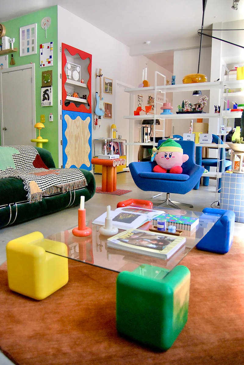 Decorative pillow tops blue arm chair in eclectic living room.