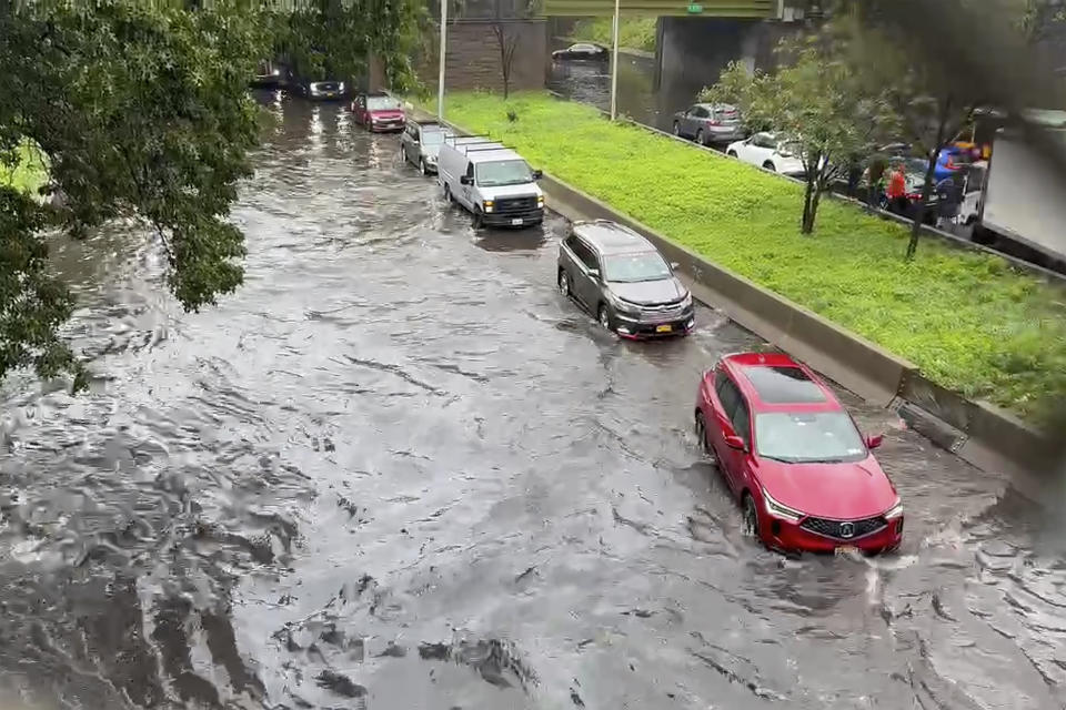 In this photo taken from video, traffic makes its way through flood waters along the Brooklyn Queens Expressway , Friday, Sept. 29, 2023, in New York. A potent rush-hour rainstorm has swamped the New York metropolitan area. The deluge Friday shut down swaths of the subway system, flooded some streets and highways, and cut off access to at least one terminal at LaGuardia Airport. (AP Photo/Robert Bumsted)