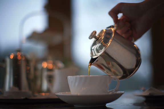 HARROGATE, ENGLAND - FEBRUARY 12: A waitress pours tea at Bettys Tea Room, Harlow Carr on February 12, 2009 in Harrogate, England. The family owned company Taylors of Harrogate have been producing it's blends of teas and coffee since 1886 and serving it's products at the famous and traditional Bettys Tea Shops. Despite recent increases in the price of tea and the surge of coffee shops, the 'cuppa' is proving to be as popular as ever with bookings in Britain's discerning tea rooms being made weeks in advance. Consumption also increases during a recession as tea lovers take solace drinking tea.  (Photo by Christopher Furlong/Getty Images)