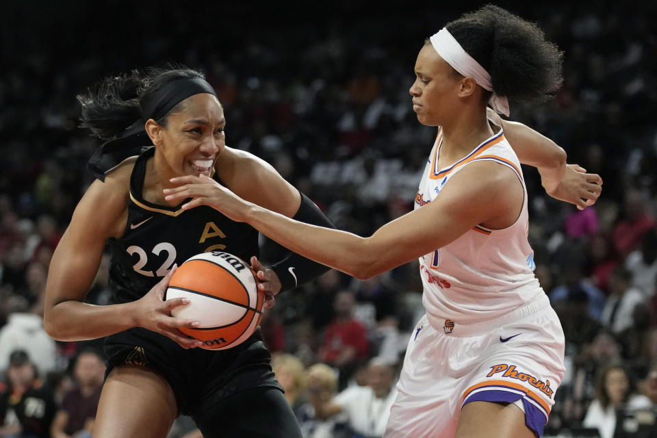 Las Vegas Aces forward A'ja Wilson (22) drives into Phoenix Mercury forward Brianna Turner (21) during the first half in Game 1 of a WNBA basketball first-round playoff series Wednesday, Aug. 17, 2022, in Las Vegas. (AP Photo/John Locher)