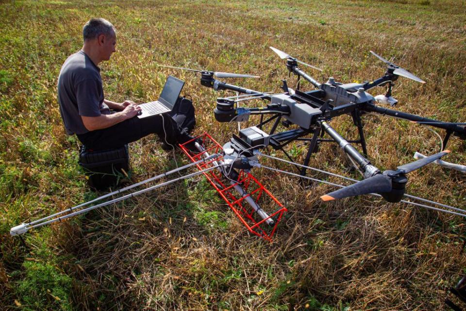 An operator launches a drone during a press tour set to demonstrate the integration of AI into the process of humanitarian demining in Zhytomyr Oblast. (Photo by Ukrinform/NurPhoto via Getty Images)