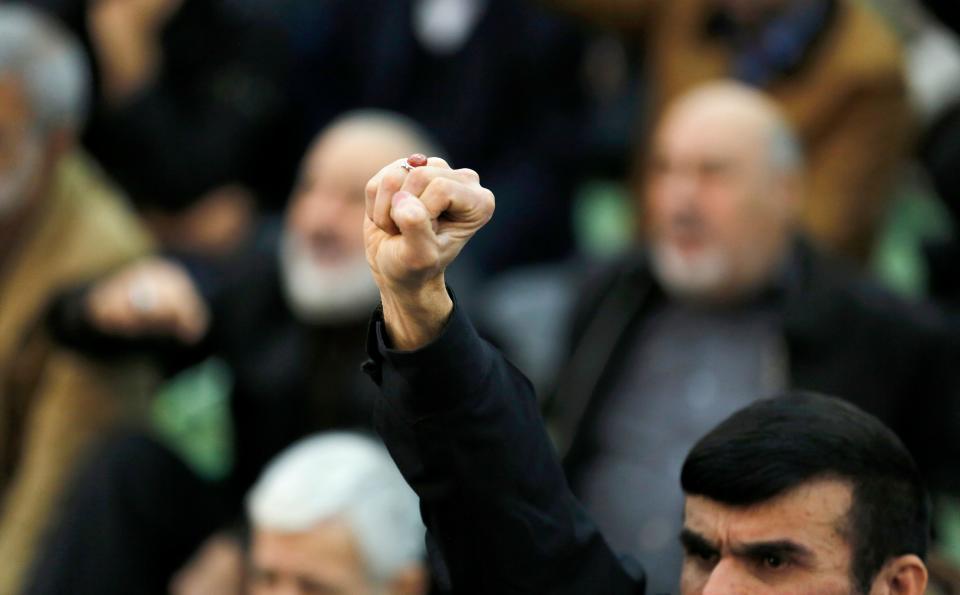 <p>An Iranian worshipper raises his fist during the friday prayers at the Imam Khomeini mosque in Tehran, on Jan. 5, 2018. (Photo: Atta Kenare/AFP/Getty Images) </p>