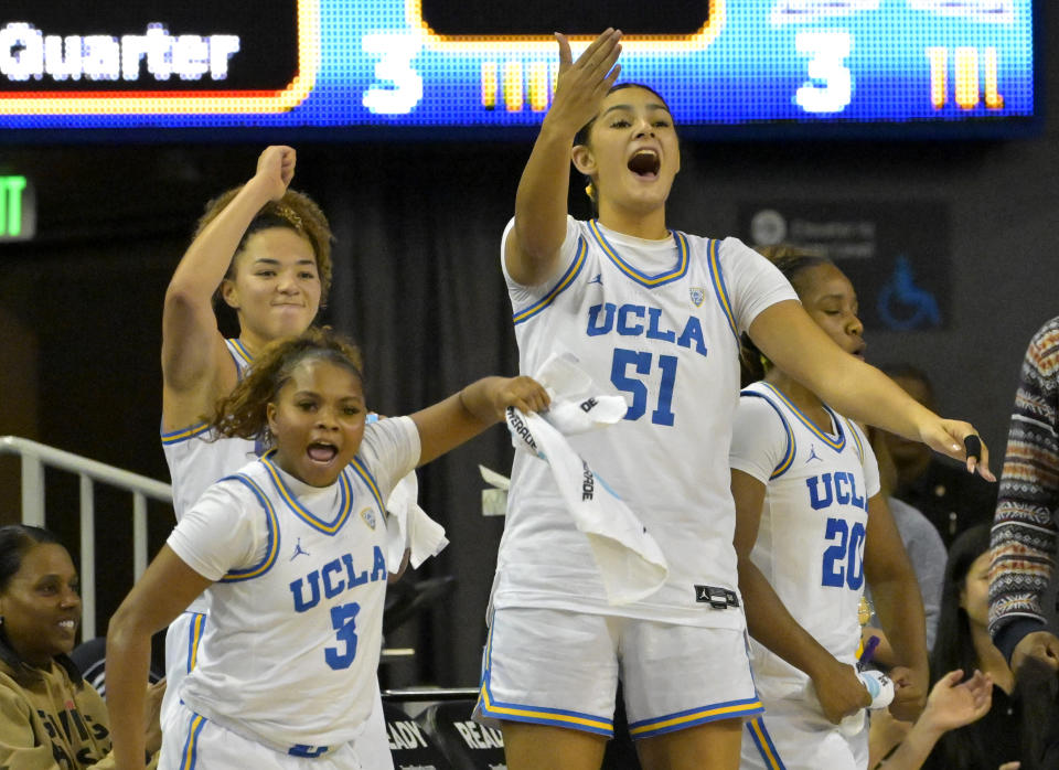 UCLA guard Londynn Jones, guard Kiki Rice, center Lauren Betts and guard Charisma Osborne celebrate on the bench during a game against Hawaii on Dec. 21, 2023, in Los Angeles. (AP Photo/Jayne Kamin-Oncea)