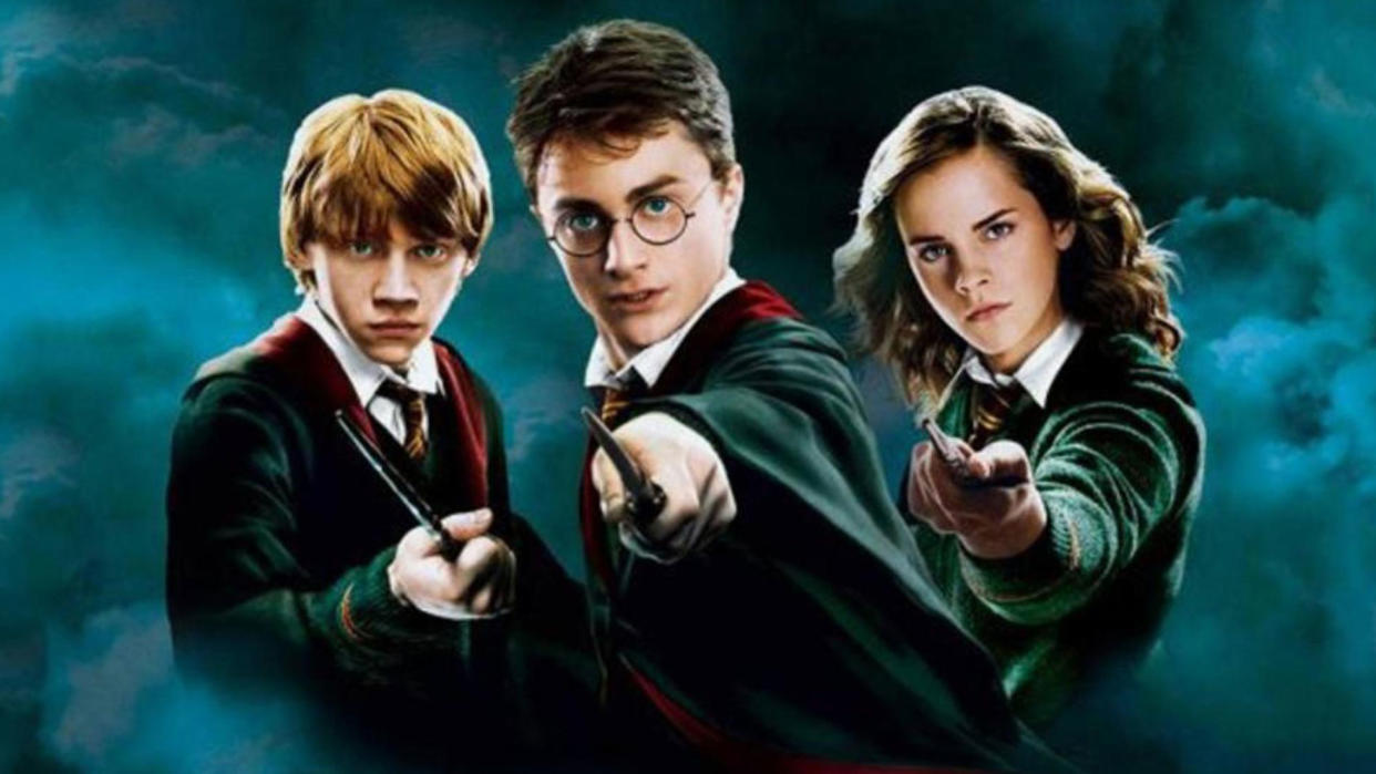  A promo shot for the first Harry Potter movie showing Ron, Harry and Hermione dressed in their Hogwarts uniform and pointing their wands at the camera. 