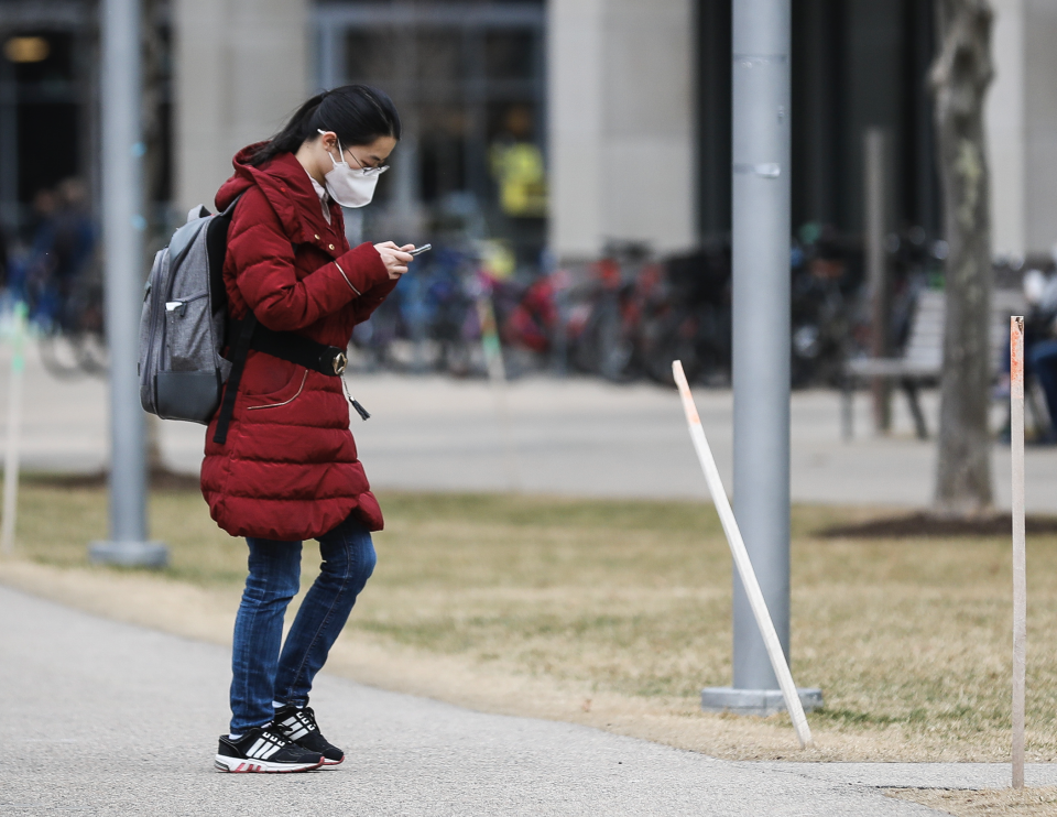 A person wears a mask while walking though MIT's campus in Cambridge, MA on March 10, 2020. (Photo: Erin Clark for The Boston Globe via Getty Images)