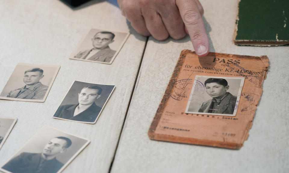 Anna Salton Eisen, daughter of Holocaust survivors, points to a photo of her father, George Lucius Salton, made along with another photo he saved after his internment in Nazi work camps, during an interview in Westlake, Texas on Wednesday, Oct. 6, 2021. “Seeing the faces of all of them really brought the story to life,” said Eisen, who discovered the photos while moving her mother, Ruth Salton, 99, from Florida to the Dallas area. (AP Photo/LM Otero)