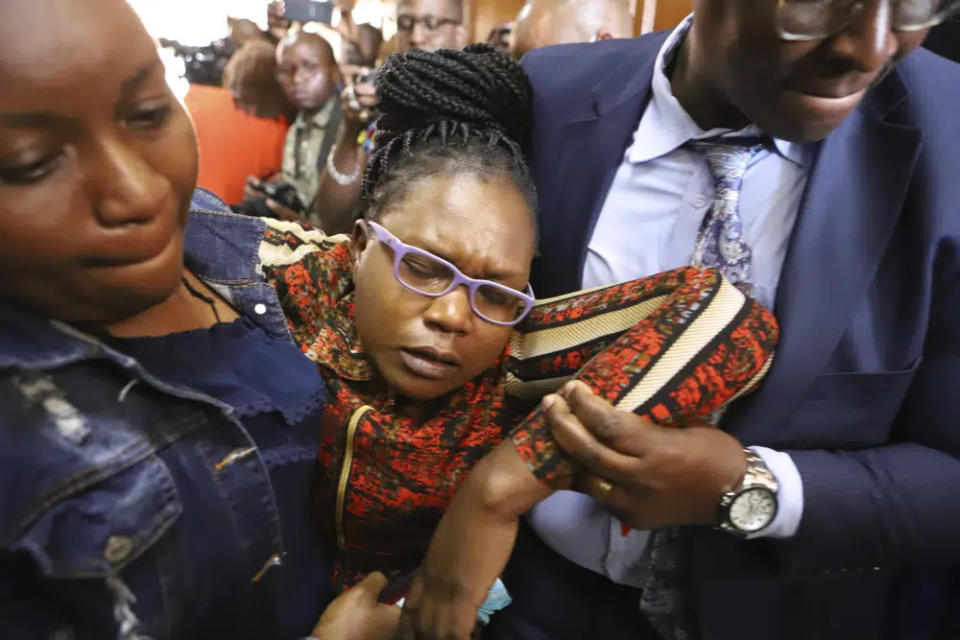 Rebecca Mwenda, wife to Josphert Mwenda who was murdered alongside human rights lawyer Willy Kimani and taxi driver Joseph Muiruri, faints during sentencing of the convicts at Milimani Law Courts, Kenya’s capital Nairobi Friday Feb. 3, 2023. (AP photo)