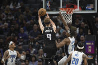 Orlando Magic center Wendell Carter Jr. (34) goes up to block the shot of Sacramento Kings guard Kevin Huerter (9) in the first quarter in an NBA basketball game in Sacramento, Calif., Monday, Jan. 9, 2023. (AP Photo/José Luis Villegas)