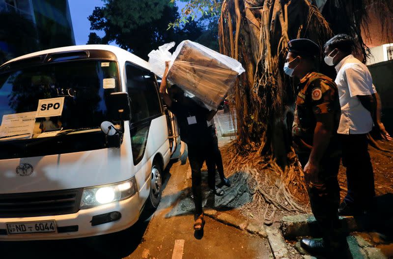 An election officer arrives with a ballot box to a counting center, after the voting ended during the country's parliamentary election in Colombo