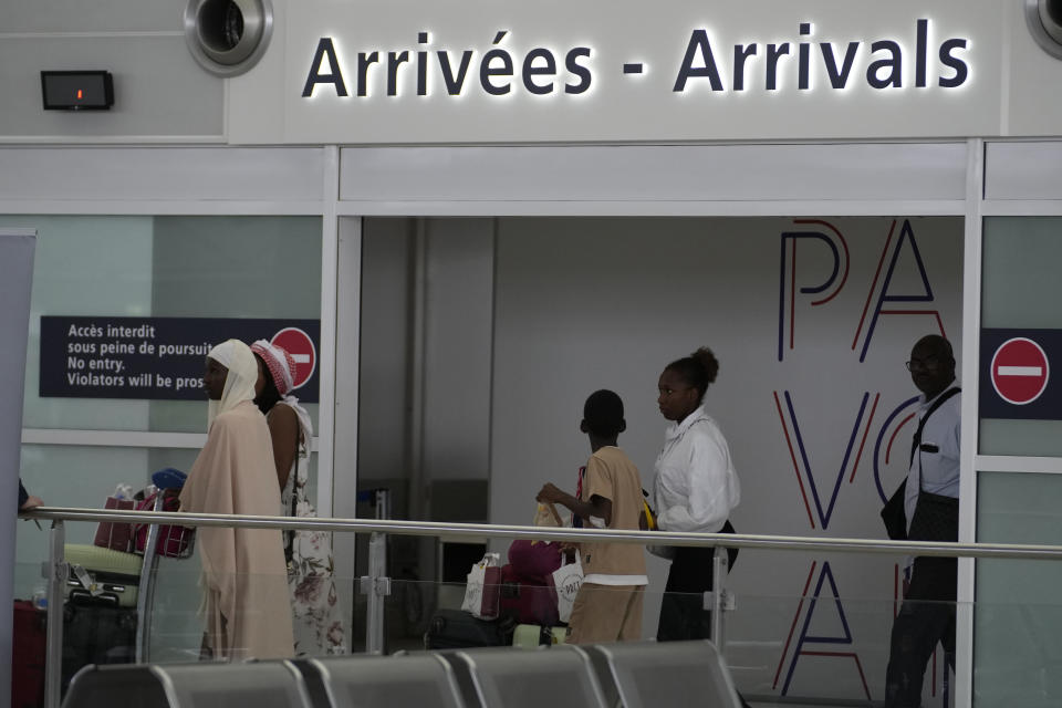 People arrive after being evacuated from Niger at the Roissy Charles de Gaulle airport, north of Paris, France, Wednesday, Aug. 2, 2023. European militaries are continuing to evacuate foreign nationals from Niger, with a third French military flight expected to depart the African nation's capital. Defense chiefs from West Africa's regional bloc are set to meet to discuss last week's coup against the country's democratically elected president. (AP Photo/Christophe Ena)