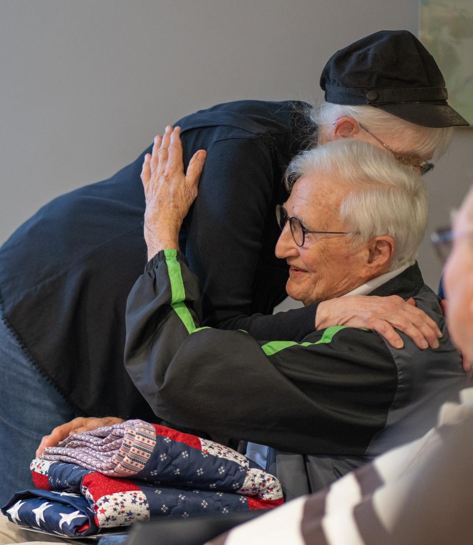 Veterans Last Patrol volunteers gathered for an Honor Ceremony on Nov. 10, 2022 at the Parker assisted living facility in Downtown Greenville. Volunteer Kay Williams hugs veteran Richard Wright after presenting him a quilt of honor.