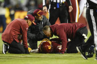 Washington Football Team running back J.D. McKissic (41) lies on the ground and is attended to by team officials before being carted off the field during the second half of an NFL football game against the Seattle Seahawks, Monday, Nov. 29, 2021, in Landover, Md. (AP Photo/Nick Wass)