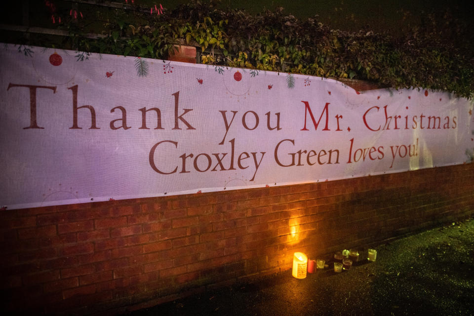 Candles and messages left outside Dave Edwards aka Mr Christmas's home in Croxley Green Rickmansworth. See SWNS story SWCAchristmas. The daughter of an OAP known as 'Mr Christmas' fulfilled her father's dying wish last night (Sat) and switched on his dazzling light display - just 24 hours after he passed away. Dave Edwards, 86, became a local celebrity in his village of Croxley Green, Watford, Herts., for covering his house with amazing light displays over the last 42 years. Every year the grandfather-of-two went bigger and better as he added more lights to his collection, turning his home and garden into a Christmas wonderland. The real-life 'Mr Christmas' had raised hundreds of pounds for charities over the years, as hundreds of people traditionally gathered in the street to watch the switch-on event.