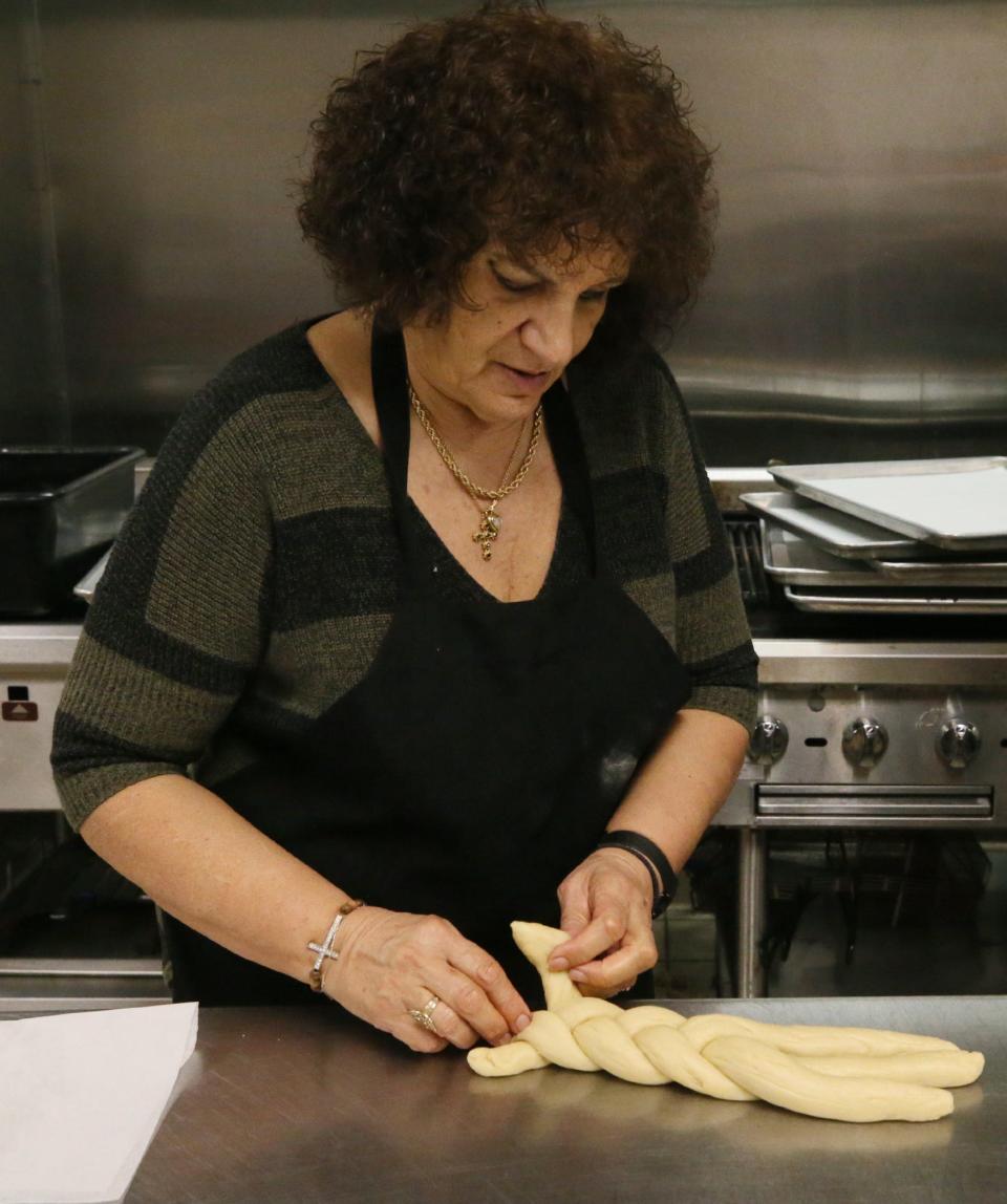 Irene Kantaras braids dough for tsourekia Easter bread with volunteer bakers from Annunciation's Philoptochos and Archangel Michael's Kalymnian Society of Campbell, Ohio, at Akron's Annunciation Greek Orthodox Church Tuesday.