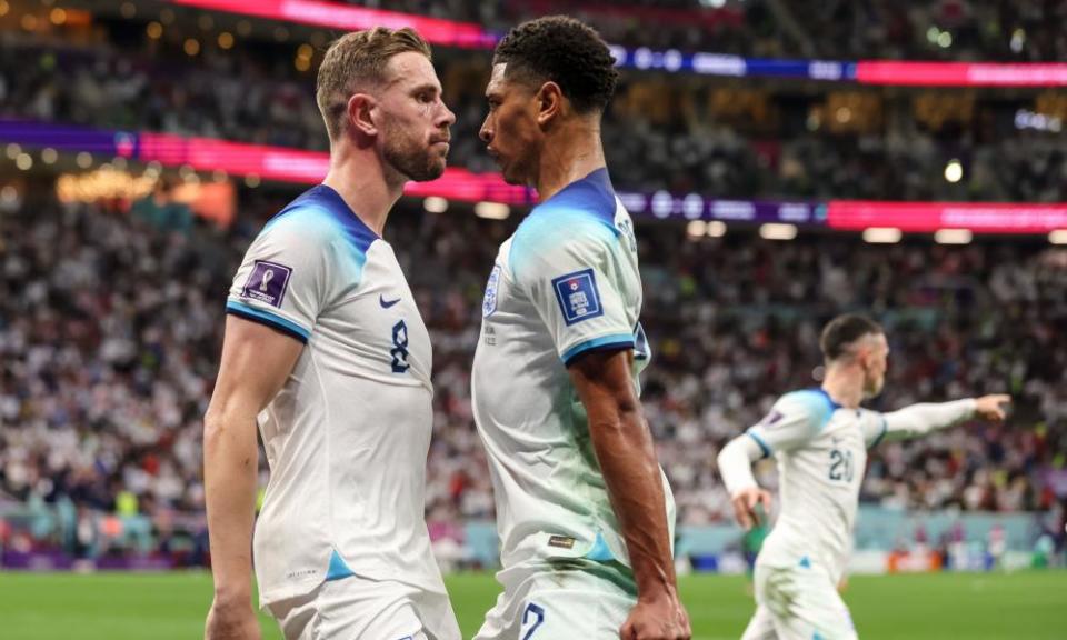 Jordan Henderson celebrates with Jude Bellingham after scoring England’s first goal.