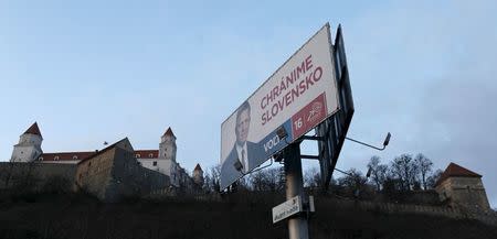 An election poster shows a candidate of Smer party and Slovakia's Prime Minister Robert Fico in front of the Bratislava Castle in Bratislava, Slovakia, March 4, 2016. REUTERS/David W Cerny