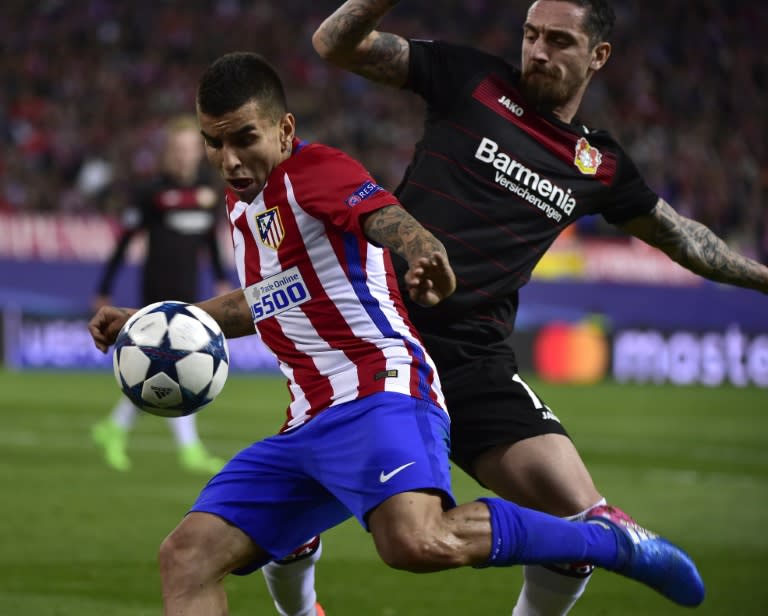 Atletico Madrid's forward Angel Correa (L) vies with Leverkusen's defender Roberto Hilbert during the UEFA Champions League round of 16 second leg football match March 15, 2017