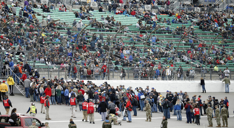 Fans return to the stands following an infield concert before a NASCAR Cup Series auto race at Kansas Speedway in Kansas City, Kan., Saturday, May 11, 2019. (AP Photo/Colin E. Braley)