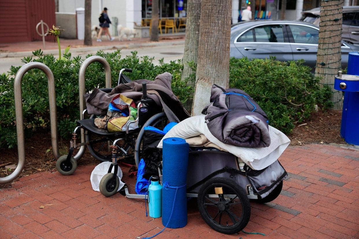 A cart containing blankets, pillows, supplies and a wheelchair sits unattended at Beaches Town Center in Atlantic Beach.