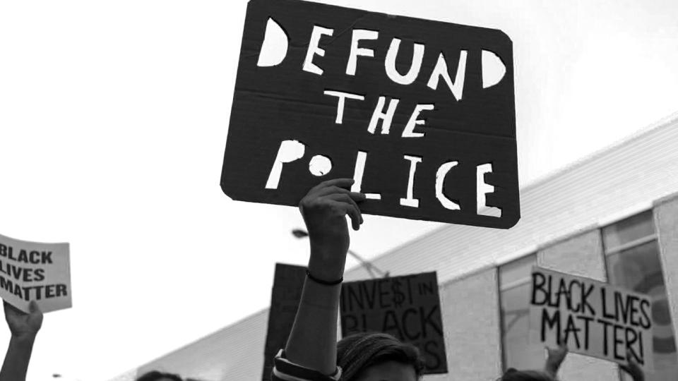 Protesters carry a "Defund the Police" sign on West Division Street during the March of Justice from Union Park to Cabrini-Green on Saturday, June 6, 2020 in Chicago to demand police accountability. (Brian Cassella/Chicago Tribune/Tribune News Service via Getty Images)