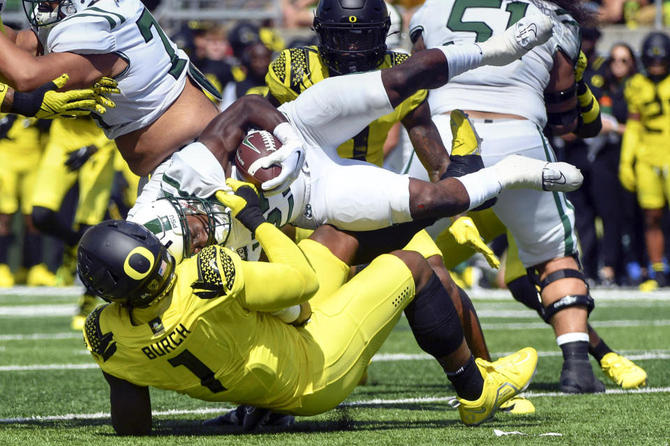 Oregon defensive end Jordan Burch (1) tackles Portland State running back Christian Grubb (23) during the first half of an NCAA college football game Saturday, Sept. 2, 2023, in Eugene, Ore. (AP Photo/Andy Nelson)