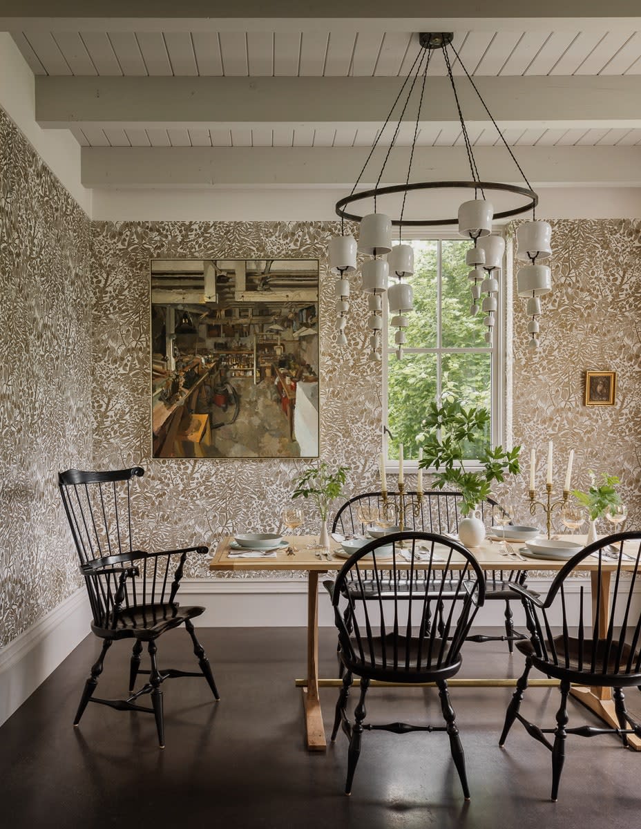 The dining room is adorned with a Marthe Armitage wallpaper. The chandelier was designed by Helgerson, and the table was designed and made by Doulis. The dining seats are from Great Windsor Chairs. Speaking of the house at large, Helgerson reflects, “It has a formality at first glance that we think reveals itself to be both livable and gracious.”