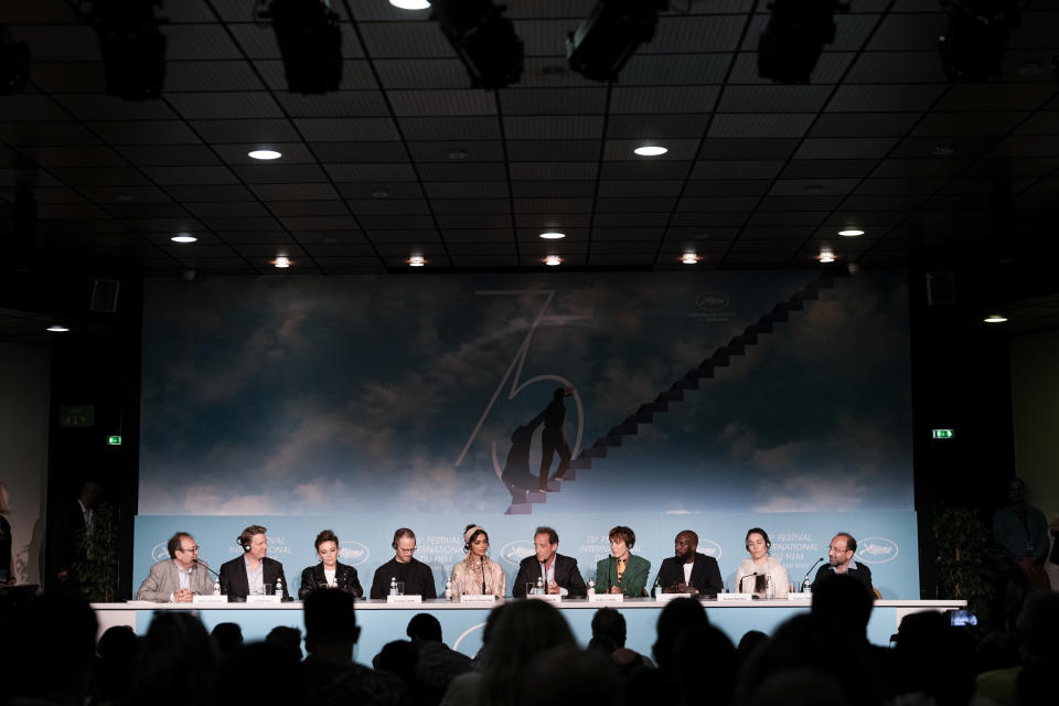 Didier Allouch, from left, jury members Jeff Nichols, Jasmine Trinca, Joachim Trier, Deepika Padukone, jury president Vincent Lindon, jury members Rebecca Hall, and Asghar Farhadi speak at the press conference for the jury at the 75th international film festival, Cannes, southern France, Tuesday, May 17, 2022. (AP Photo/Petros Giannakouris)