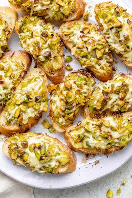 White Cheddar Brussels Sprouts & Pistachio Crostini with Hot Honey