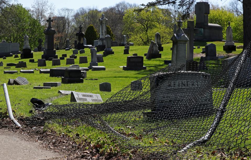 A motorist crashed through the fence at St. Bernard Catholic Cemetery over the weekend damaging 21 grave markers. The downed fence is pictured Monday, April 22, 2024, in Akron, Ohio.