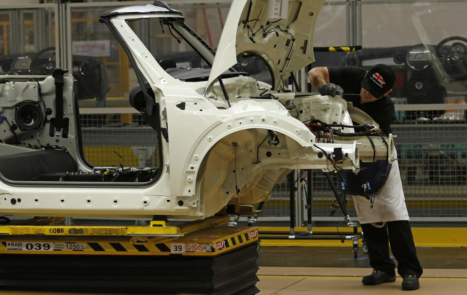 An employee works on a Mini at BMW's plant in Oxford