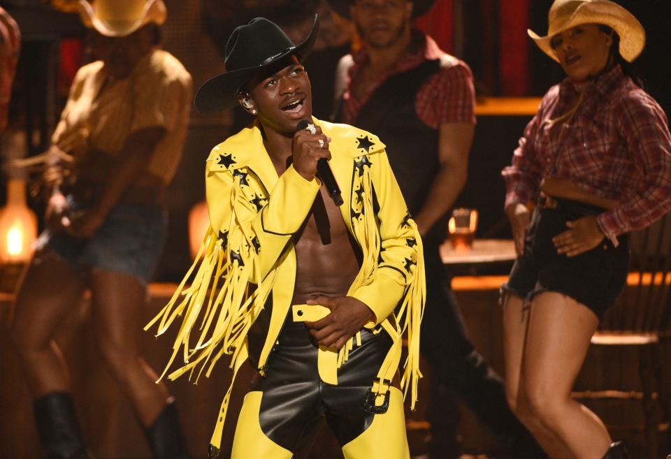 This June 23, 2019 file photo shows Lil Nas X performing his genre-bending "Old Town Road" at the BET Awards in Los Angeles. The rapper won many awards, including Grammys for best music video and best pop duo/group performance, an American Music Award for favorite rap/hip-hop and a CMA award for musical event of the year.