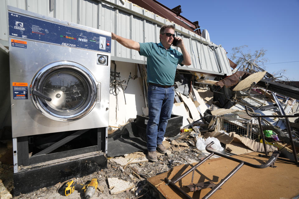 Jerry Stevens stands by one of his remaining large load washing machines that survived the killer tornado of March 24, that ripped through Rolling Fork, Miss., destroying or heavily damaging much of the town, as photographed March 29, 2023. He and a partner have owned a laundromat and car washing facility in the Mississippi Delta town for over 20 years, both destroyed by the tornado. (AP Photo/Rogelio V. Solis)