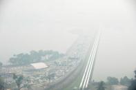 A general view of the causeway from Singapore to Johor Bahru (background), obscured by thick haze, on June 21, 2013. Singapore's smog index hit the critical 400 level, making it potentially life-threatening to the ill and elderly people, according to a government monitoring site