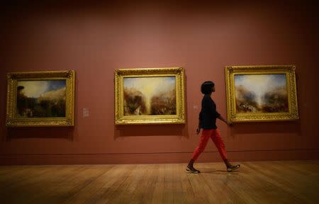 File photograph shows Silaja Birks posing for the media as she studies paintings by artist JMW Turner at The Tate Britain in London September 8, 2014. REUTERS/Dylan Martinez/Files