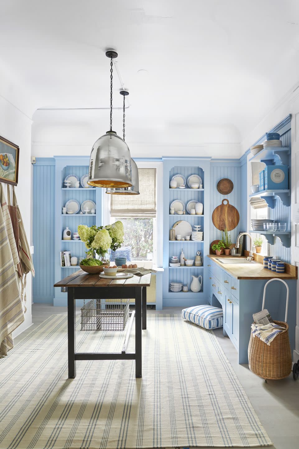 blue and white kitchen with sky colored open shelving, cabinetry, and beadboard accent walls