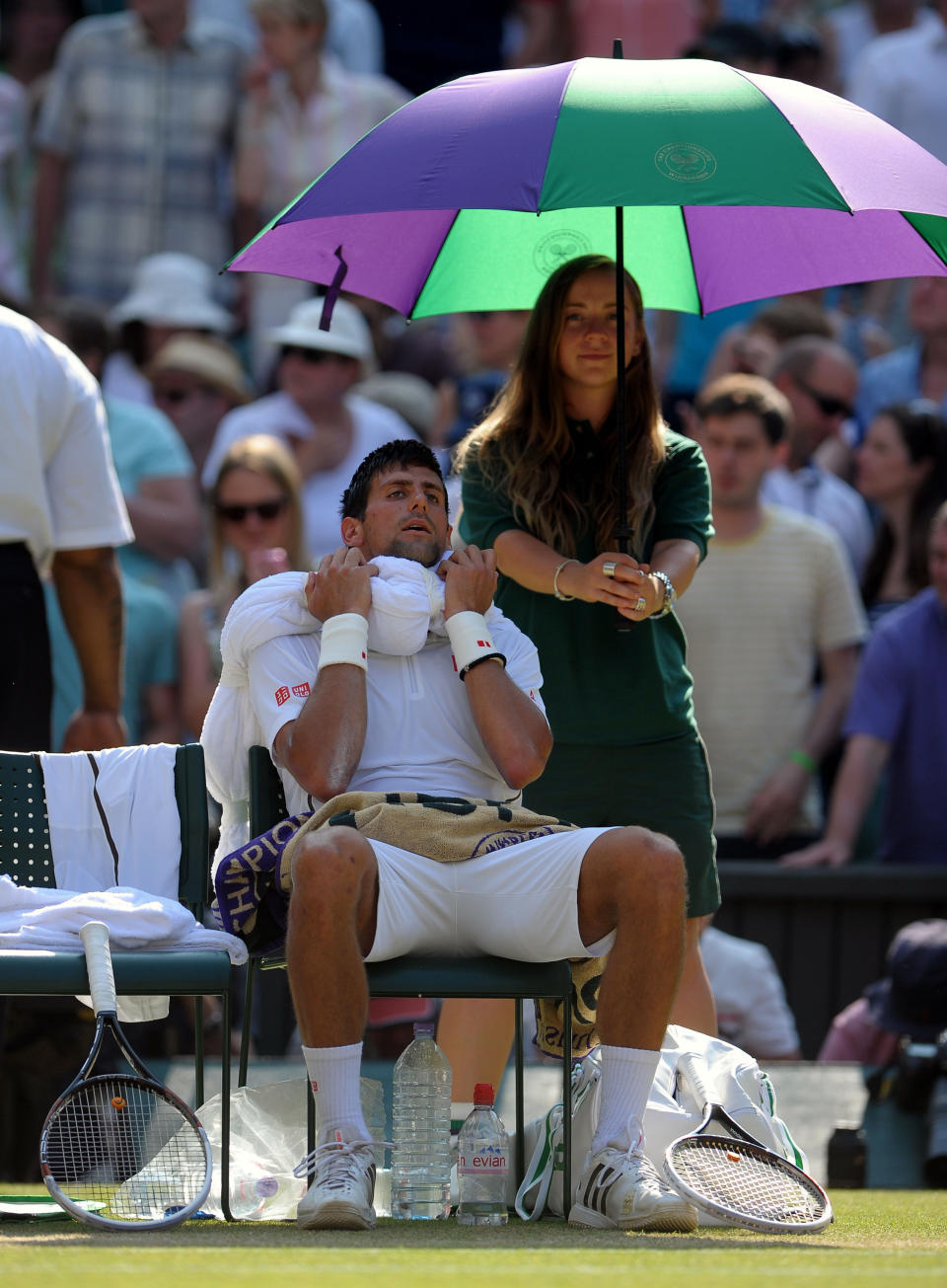 Serbia's Novak Djokovic sits with a towel of ice on his head during a break of ends in his match against Great Britain's Andy Murray on day thirteen of the Wimbledon Championships at The All England Lawn Tennis and Croquet Club, Wimbledon.