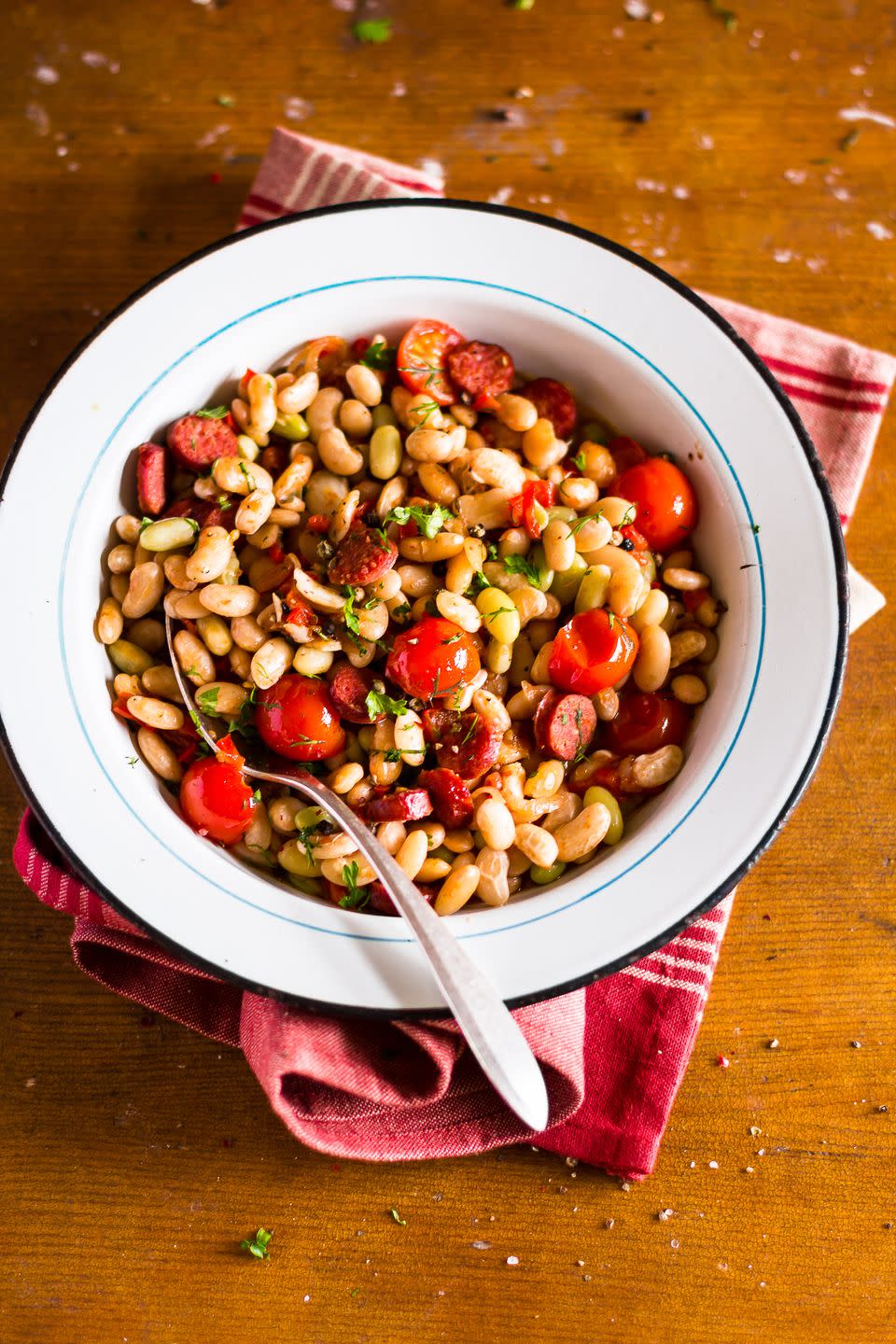 <p>That liquid your canned beans and veggies are swimming in is mostly salt and starch. A strain followed by a quick 10-second rinse will remove about 40% of the sodium. Then you can “add ½ cup to pretty much anything you’re eating for lunch or dinner every day,” says <a href="https://www.thebloatedbellywhisperer.com/" rel="nofollow noopener" target="_blank" data-ylk="slk:Tamara Duker Freuman, R.D.;elm:context_link;itc:0;sec:content-canvas" class="link ">Tamara Duker Freuman, R.D.</a>, author of <em>The Bloated Belly Whisperer</em>. Fold into sauces and salads, add to veggie side dishes, mix with ground meat, and more. “Eating beans/legumes every day is the single common dietary factor among people who live the longest, most disease-free lives,” says Duker Freuman.</p>