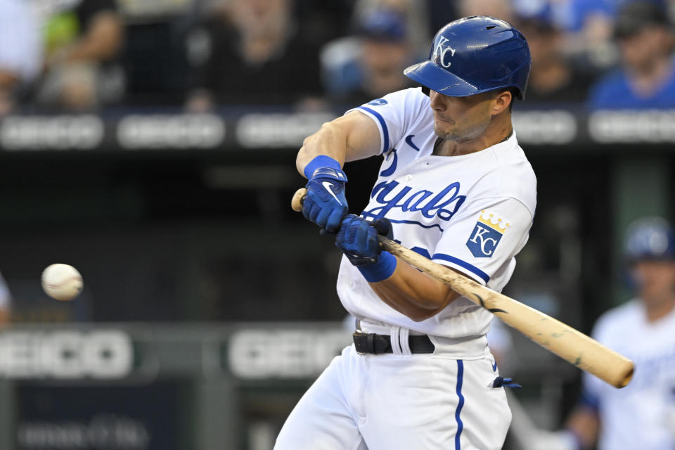 Kansas City Royals' Andrew Benintendi hits a single against the Detroit Tigers during the first inning of a baseball game, Tuesday, July 12, 2022, in Kansas City, Mo. (AP Photo/Reed Hoffmann)