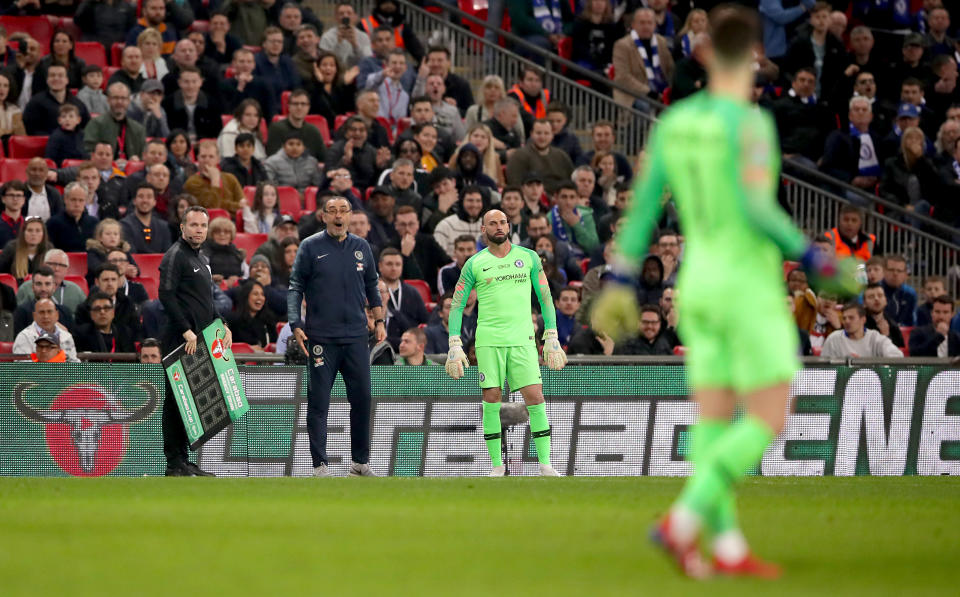 (Above) Chelsea manager Maurizio Sarri reacts with shock after goalkeeper Kepa Arrizabalaga waves off his substitution late in the League Cup final. (Below) Chelsea backup keeper Willy Caballero shrugs amid the confusion at Wembley Stadium. (Both images via Getty)