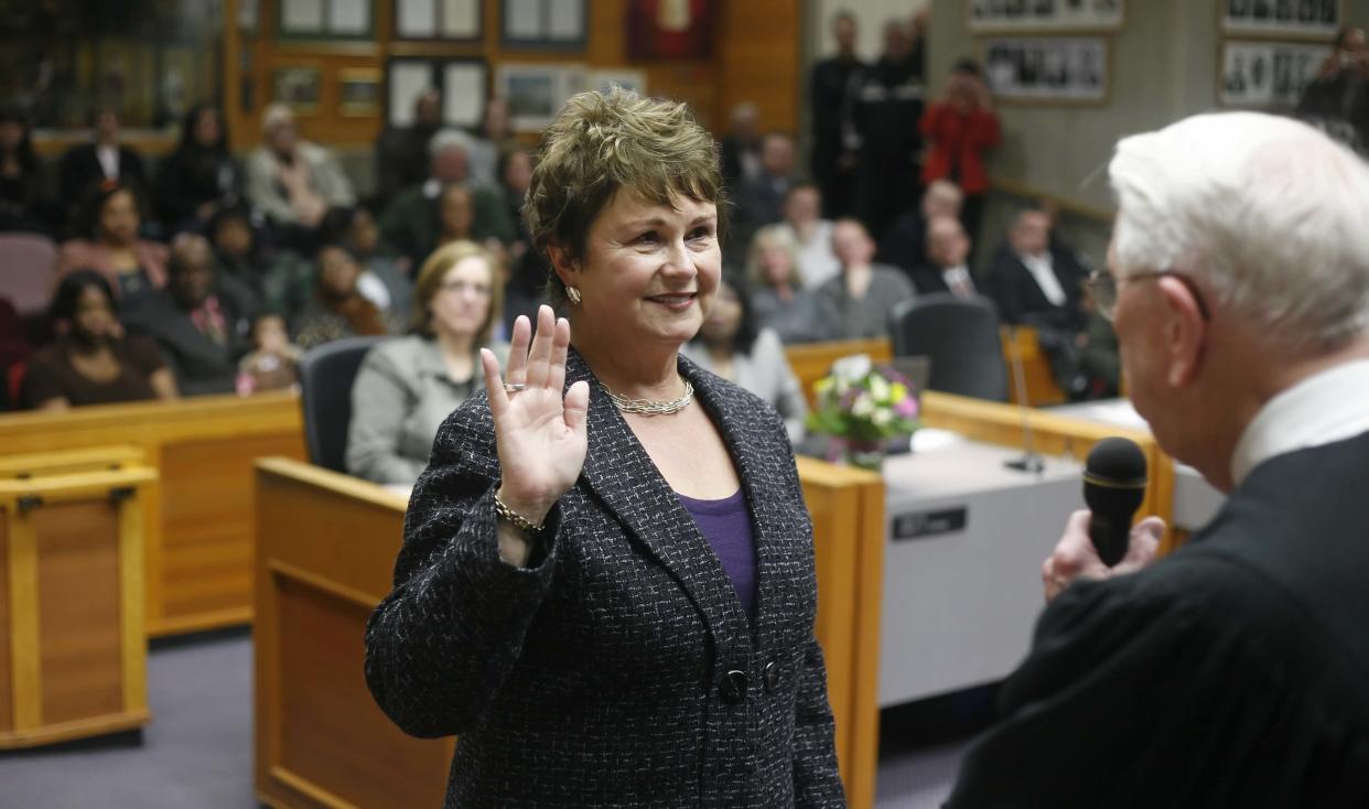 Edwin J. Peterson administers the oath of office to his wife, Anna Peterson, when she is sworn in as the mayor of Salem on Jan. 11, 2011.